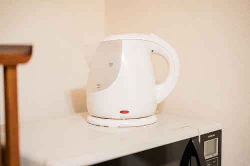 a white appliance sitting on top of a counter at Bunkyo-ku Hakusan House in Tokyo