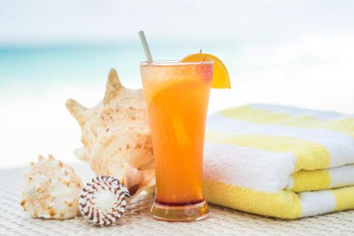 a glass of orange juice sitting on a table at Sur Beach Resort Boracay in Boracay
