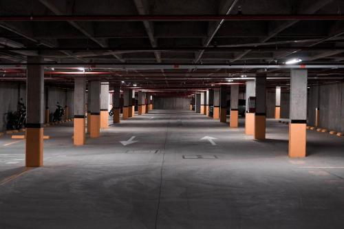 an empty parking garage with columns and lights in it at Apartamentos en el Sur de Cali, parqueadero propio, piscina, wifi in Cali