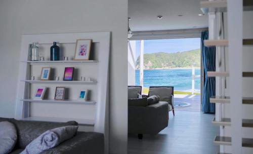 a living room with a view of the ocean at Aquaholic Iritahama in Shimoda