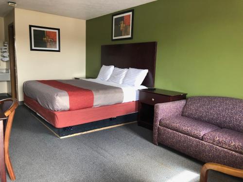 a hotel room with a bed and a couch at Salt Creek Inn in Nashville