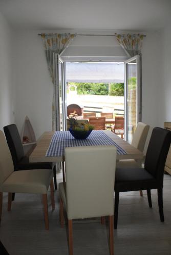 a dining room with a table and chairs at Holiday Home Radmila in Premantura