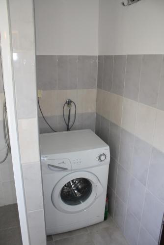 a washer and dryer in a small room at Holiday Home Radmila in Premantura