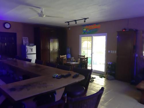 a dining room with a large wooden table and chairs at Monty's Riverside View Resort in San Antonio