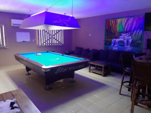 a living room with a pool table in it at Monty's Riverside View Resort in San Antonio