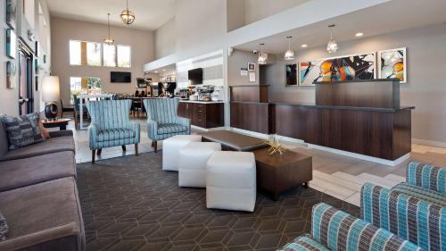 a lobby with couches and chairs and a bar at Best Western Apricot Inn in Chaney Ranch