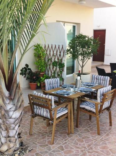 a wooden table and chairs in a patio at Estia Luxury Maisonette in Paphos