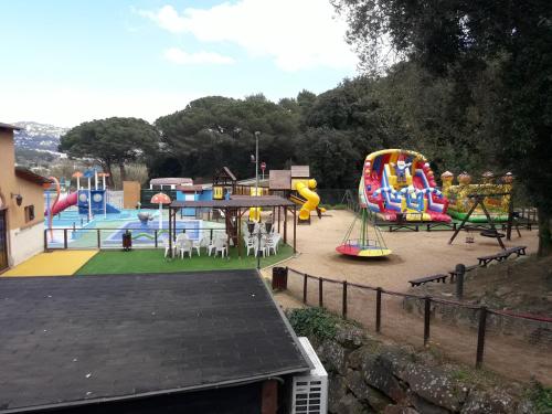 a playground with a bunch of different types of slides at LA VILLA DEL PARAISO in Vidreres