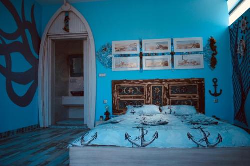 a blue bedroom with a bed with antlers on it at HemDem Alçıtepe in Canakkale