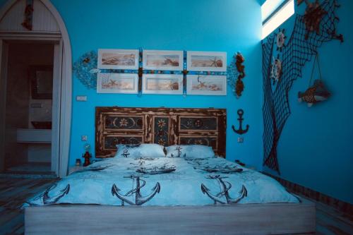 a blue bedroom with a bed with antlers on it at HemDem Alçıtepe in Canakkale