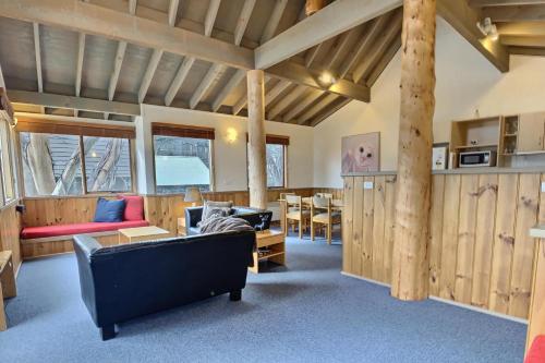 a living room with a couch and a table at snowy river in Dinner Plain