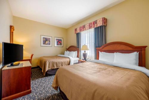 A bed or beds in a room at Clarion Inn Ormond Beach at Destination Daytona