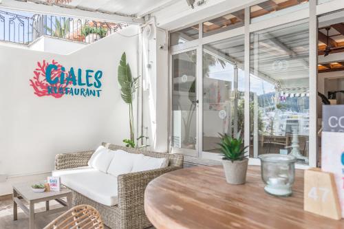 a cafe with a table and chairs and a couch at FERGUS Style Soller Beach in Port de Soller