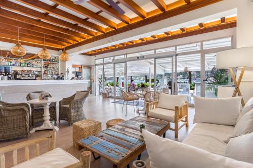 a living room with a couch and a table at FERGUS Style Soller Beach in Port de Soller