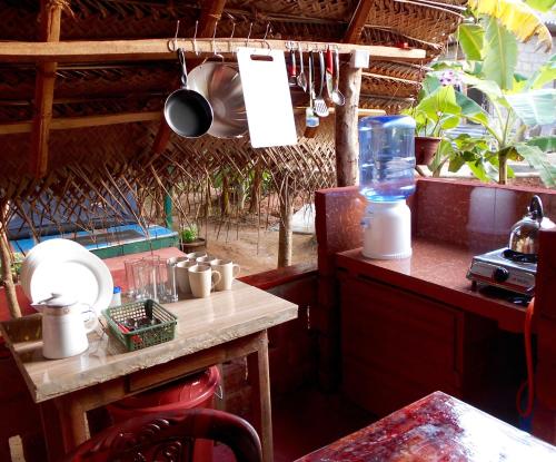 a kitchen with a table and a counter top with a counter top at HOMESTAY CAMPING ANURADHAPURA in Anuradhapura