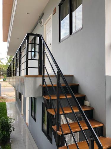a staircase leading up to a house with windows at SP Home BangSaen in Bangsaen