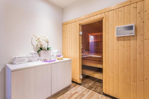 a room with a wooden partition with a counter and a kitchen at FERGUS Style Soller Beach in Port de Soller
