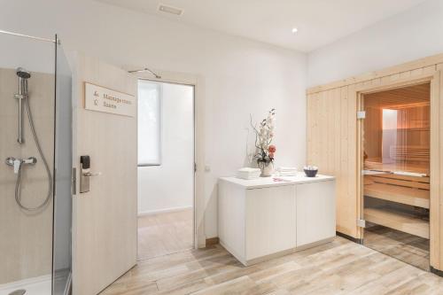 a bathroom with a shower and a white counter at FERGUS Style Soller Beach in Port de Soller