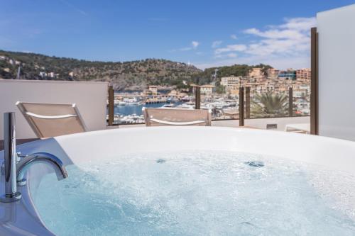 a bath tub with a view of a city at FERGUS Style Soller Beach in Port de Soller