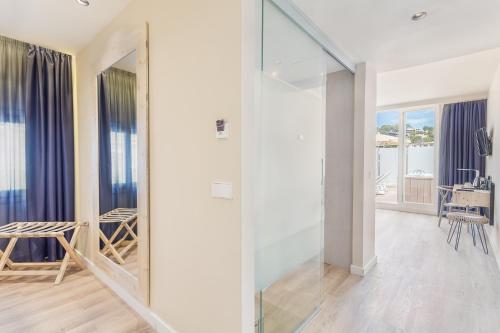 a room with a glass door leading to a living room at FERGUS Style Soller Beach in Port de Soller