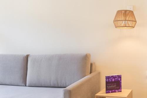 a couch with a purple box on a table at FERGUS Style Soller Beach in Port de Soller