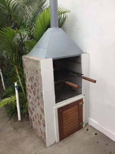 a outdoor pizza oven sitting next to a wall at Résidence ARCHANGE in Pointe-Noire