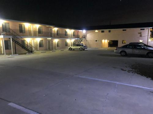 two cars parked in front of a building at night at Seaview Inn Grover Beach in Grover Beach