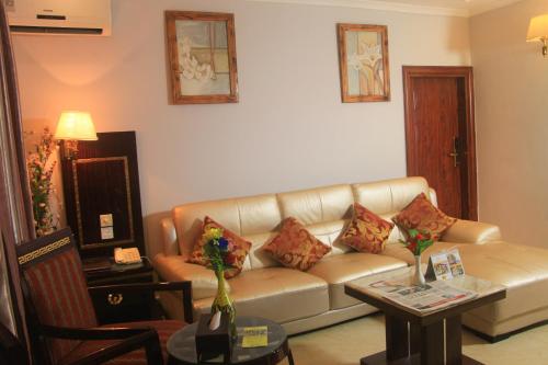 a living room with a couch and a table at Tiffany Diamond Hotels - Mtwara in Mtwara