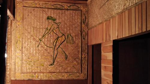 a door with a painting of a man with a bow and arrow at Havelock Farms Resort in Havelock Island