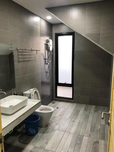 a bathroom with a sink and a toilet and a window at Aonang nine poolvilla in Ao Nang Beach