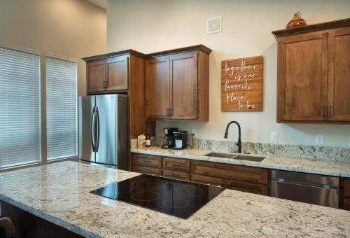 a kitchen with wooden cabinets and a stainless steel refrigerator at 11R Spring Meadow Retreat in Wawona