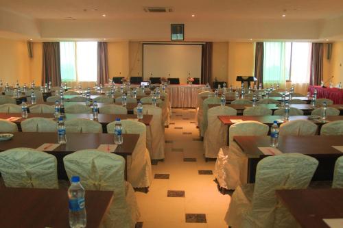 a room full of tables and chairs with bottles on them at Tiffany Diamond Hotels - Mtwara in Mtwara