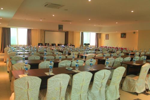 a conference room with tables and chairs and a podium at Tiffany Diamond Hotels - Mtwara in Mtwara