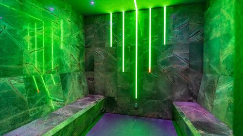 a green room with benches and lights on the wall at Hotel AquaCity Seasons in Poprad