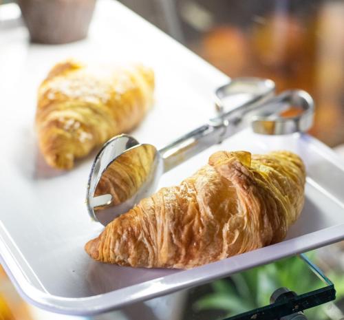 a tray with croissants and other pastries on it at Hotel Il Castello in Certaldo
