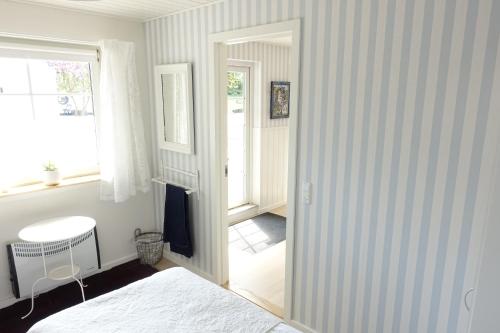 a bedroom with a door leading into a room at Lillelund bed and breakfast in Silkeborg