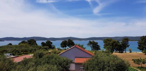a house with a view of the water at Family apartment Rita in Sveti Filip i Jakov