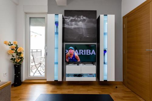 a living room with a tv in a entertainment center at Apartmani Pezerović in Soko Banja