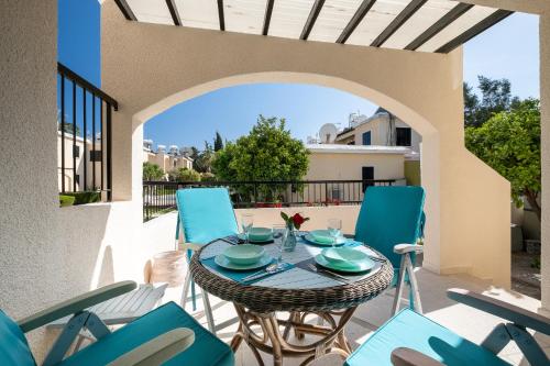 a patio with a table and chairs on a balcony at Dalia Seaside 2 Bedroom Apartment with Pool & Garden in Paphos