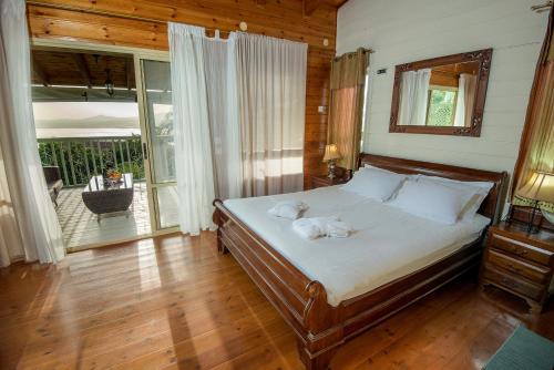 a bedroom with a bed with two towels on it at Sea of Galilee Panoramic View in Moshav Ramot