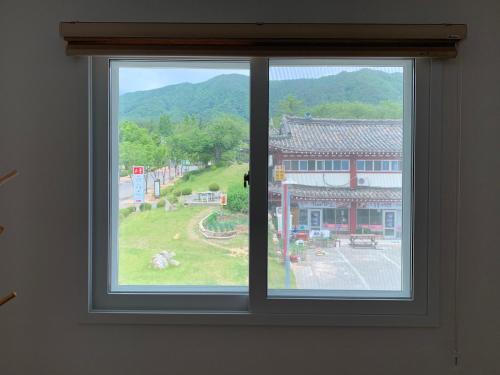a window with a view of a building at Gyeongju Roamers Stay in Gyeongju