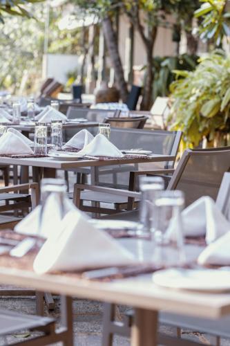 an empty tables with plates and napkins on them at The Postcard Galle in Galle