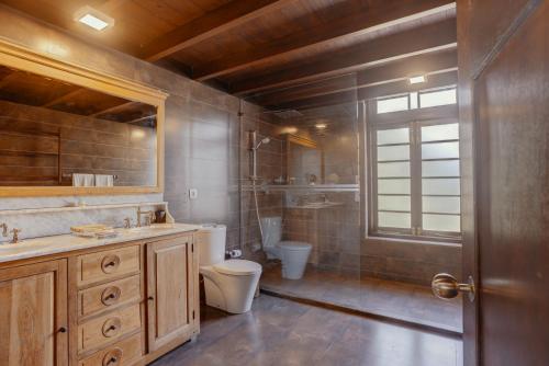 a bathroom with a toilet and a sink at The Postcard Galle in Galle