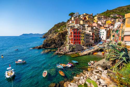 a group of boats in a body of water with buildings at La Spezia by The First - Luxury Rooms & Suites in La Spezia