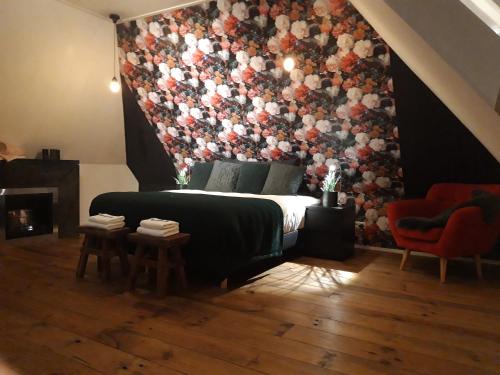 a bedroom with a bed with a large floral wall at Byonz in Groningen