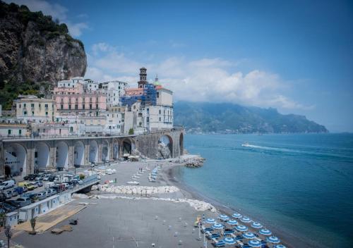 a view of a beach with buildings and the ocean at La finestra sul borgo in Atrani