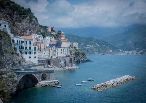 a group of buildings on a mountain next to a river at La finestra sul borgo in Atrani