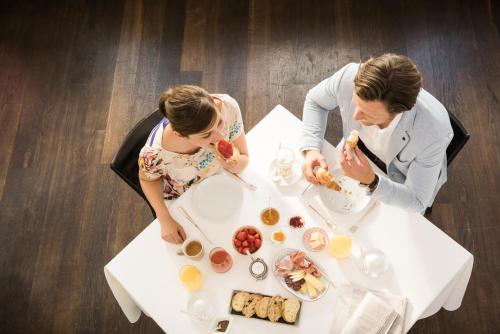 two people sitting at a table eating food at Sorell Hotel Speer in Rapperswil-Jona