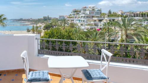a balcony with two chairs and a view of the beach at Boutique Hotel B51 in Marbella