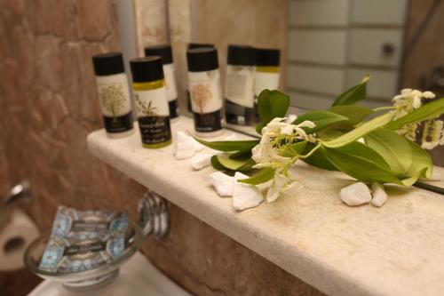 a bathroom counter with five bottles of cosmetics on it at Elia in Skála Foúrkas